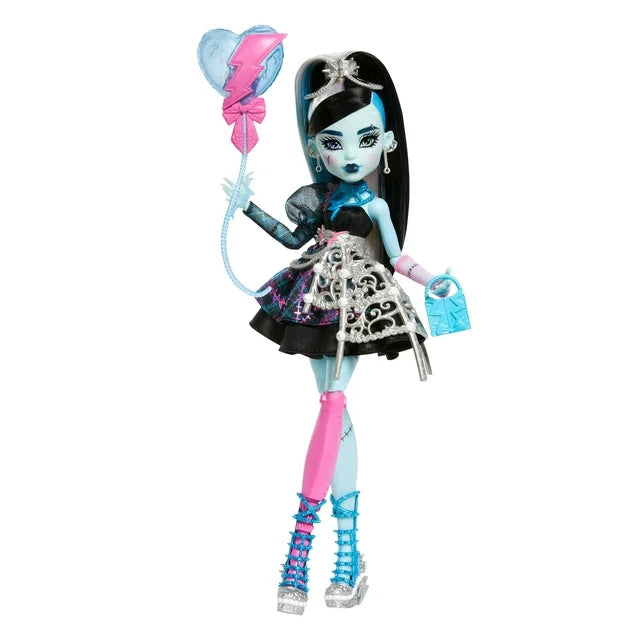 Product view of Monster High Scary Sweet Birthday Frankie Stein doll wearing an electric blue party dress and holding a lightning-shaped balloon.