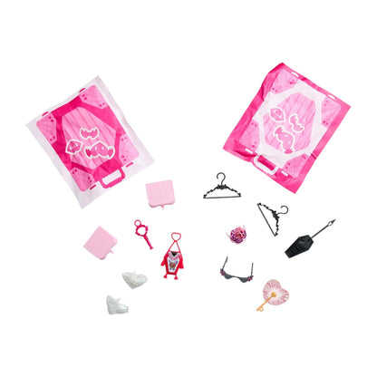 Set of miniature fashion accessories with pink packaging on a white background