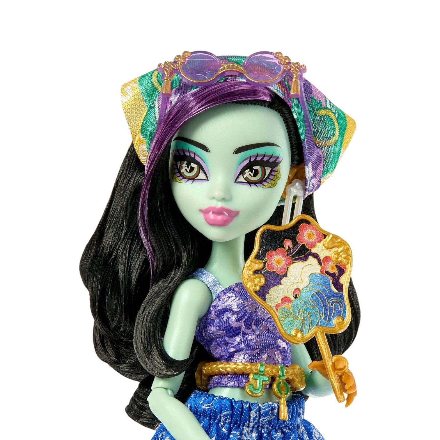 Toy doll with green skin, purple hair, and a colorful outfit on a white background