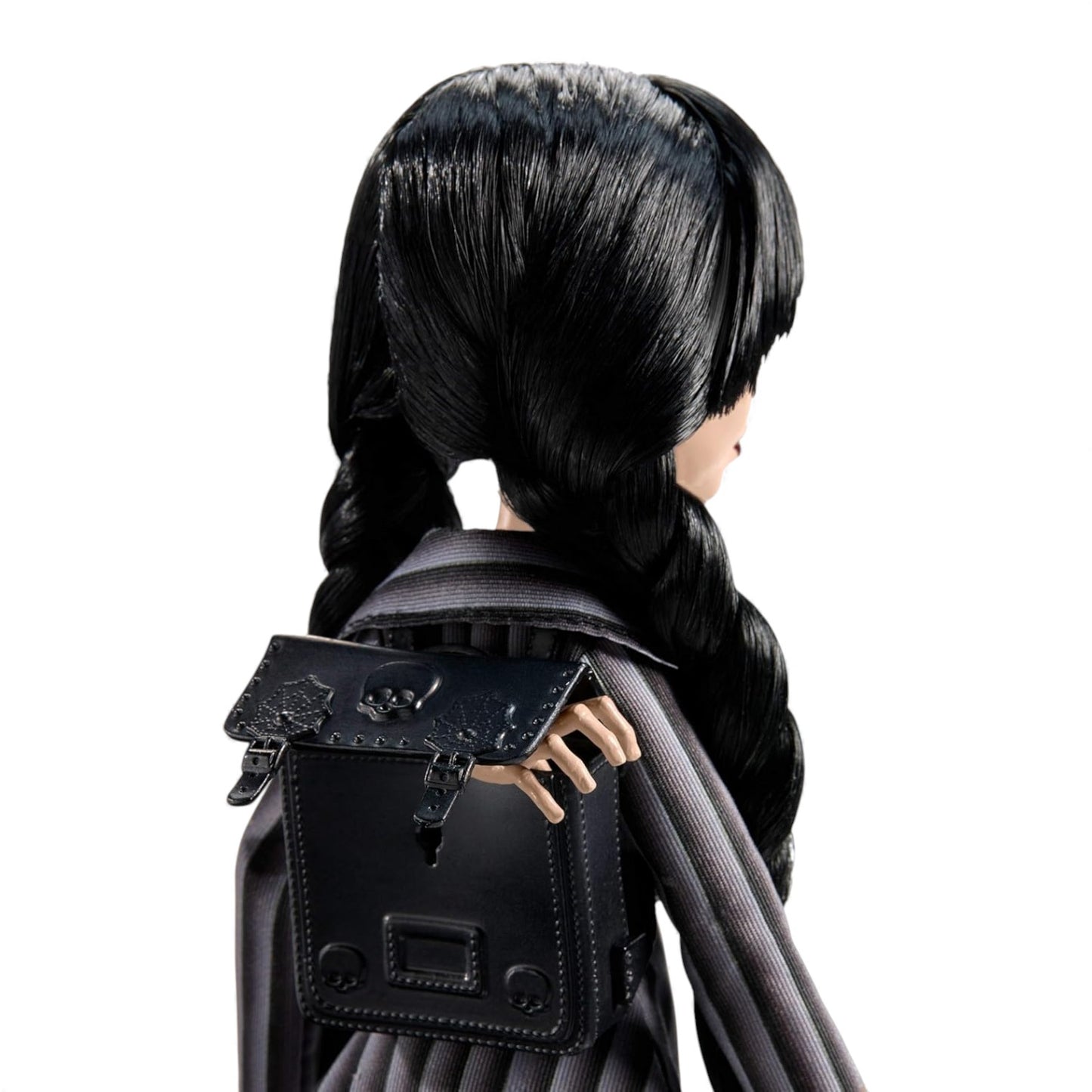 Doll with black hair and a black handbag on a white background