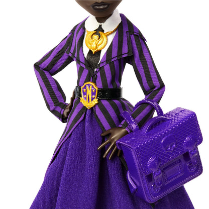Doll in a purple and black striped outfit with a matching handbag on a white background