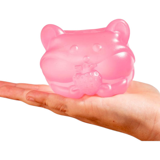 Pink gummy bear-shaped object held in a hand on a white background
