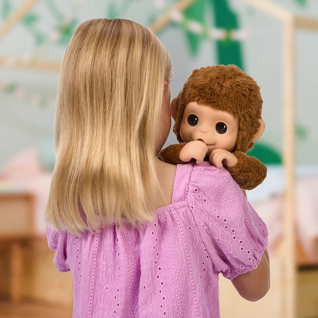 young girl holding Little Live Pets My Baby Monkey Mango interactive plush toy Canada