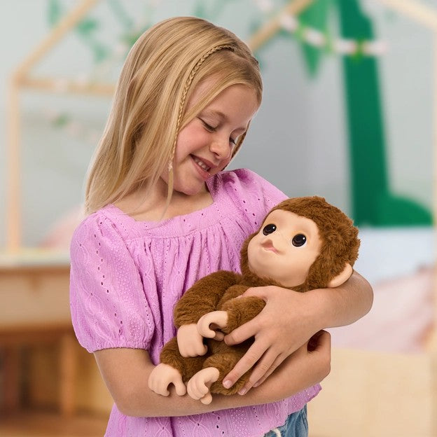 young girl holding Little Live Pets My Baby Monkey Mango interactive plush toy Canada
