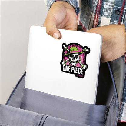 Person holding a white laptop with a 'One Piece' logo