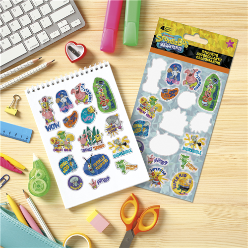 Colorful stickers on a sheet and in a packaging on a wooden surface with stationery items.