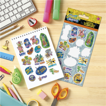 Colorful stickers on a sheet and in a packaging on a wooden surface with stationery items.