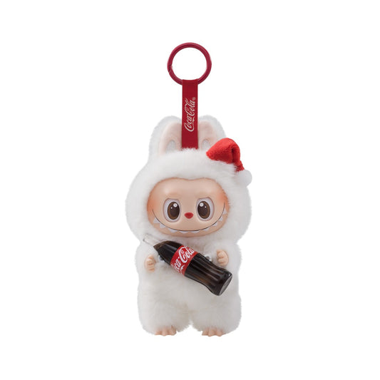 A product photo of the POP MART "The Monsters" x Coca-Cola plush pendant, showing the Labubu character in a white, fluffy Santa hat, holding a tiny Coca-Cola bottle.