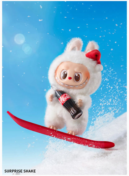 Animated Labubu the Monsters Plush in a winter outfit with a Coca-Cola bottle on a snowboard against a blue sky.