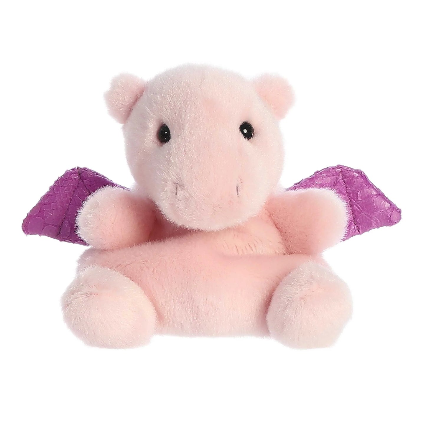 A small, soft pink plush dragon (Palm Pals Aria) sitting down, with shiny, textured purple wings and small black eyes.