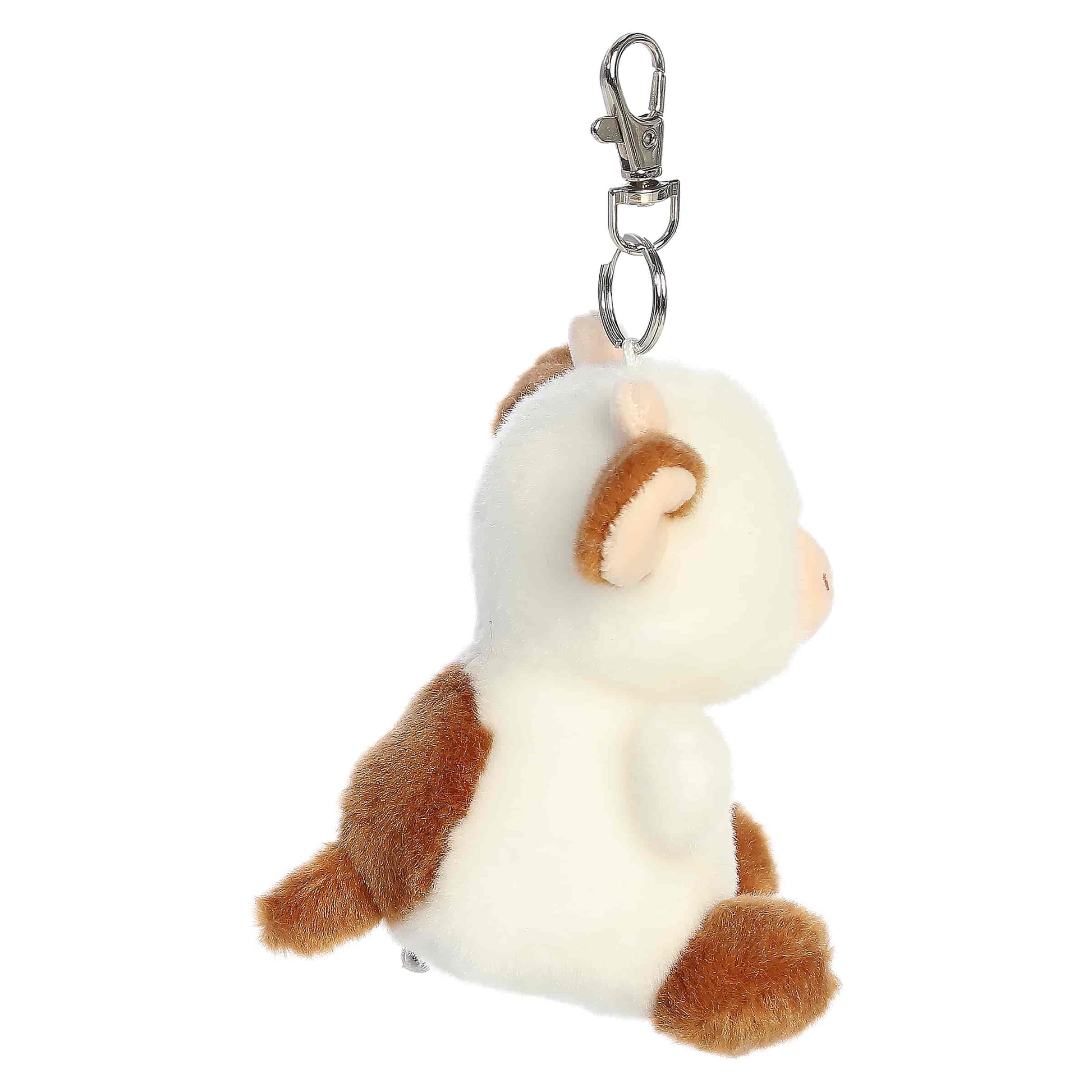Palm Pals Caroline Brown Cow Clip-On plush featuring soft brown and white fur, cute little horns, and a metal keychain clip.