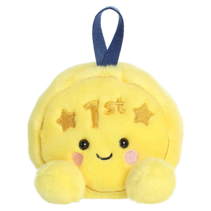 Palm Pals Champ Gold Medal, a small golden-yellow plush shaped like a first-place medal with a blue ribbon loop and a sweet smiling face.