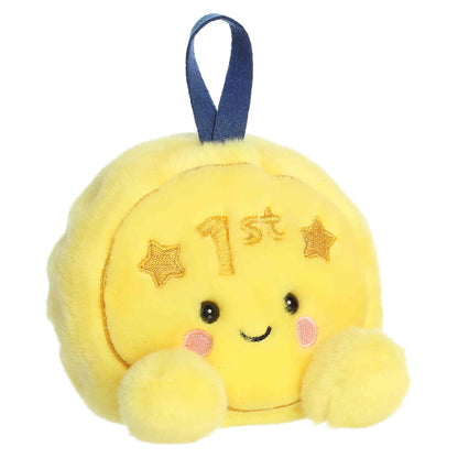 Palm Pals Champ Gold Medal, a small golden-yellow plush shaped like a first-place medal with a blue ribbon loop and a sweet smiling face.