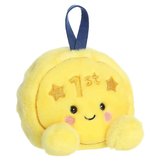 Palm Pals Champ Gold Medal, a small golden-yellow plush shaped like a first-place medal with a blue ribbon loop and a sweet smiling face.