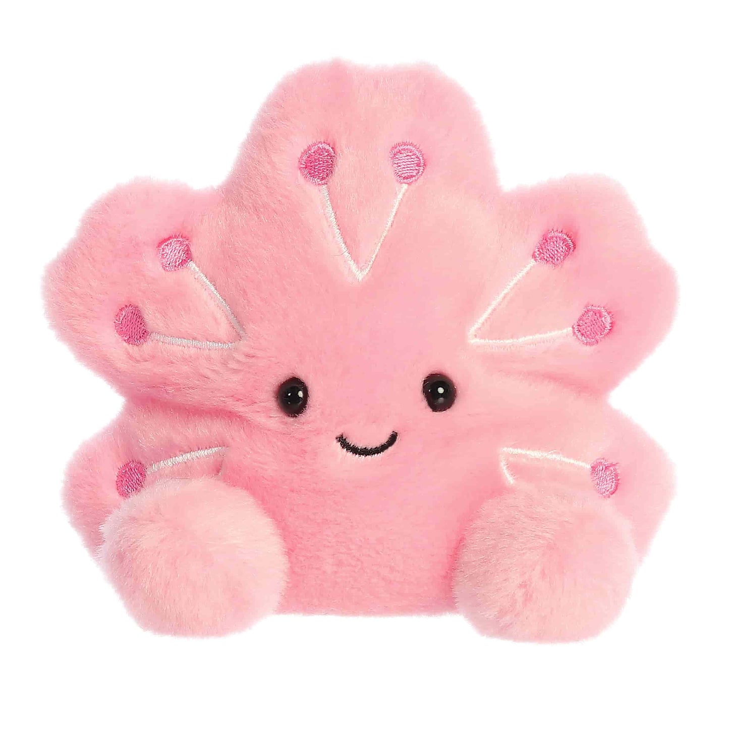 A product photo of the Palm Pals Hana Cherry Blossom 5-Inch Plush, a pink flower-shaped stuffed animal with embroidered details, sitting on a white background.