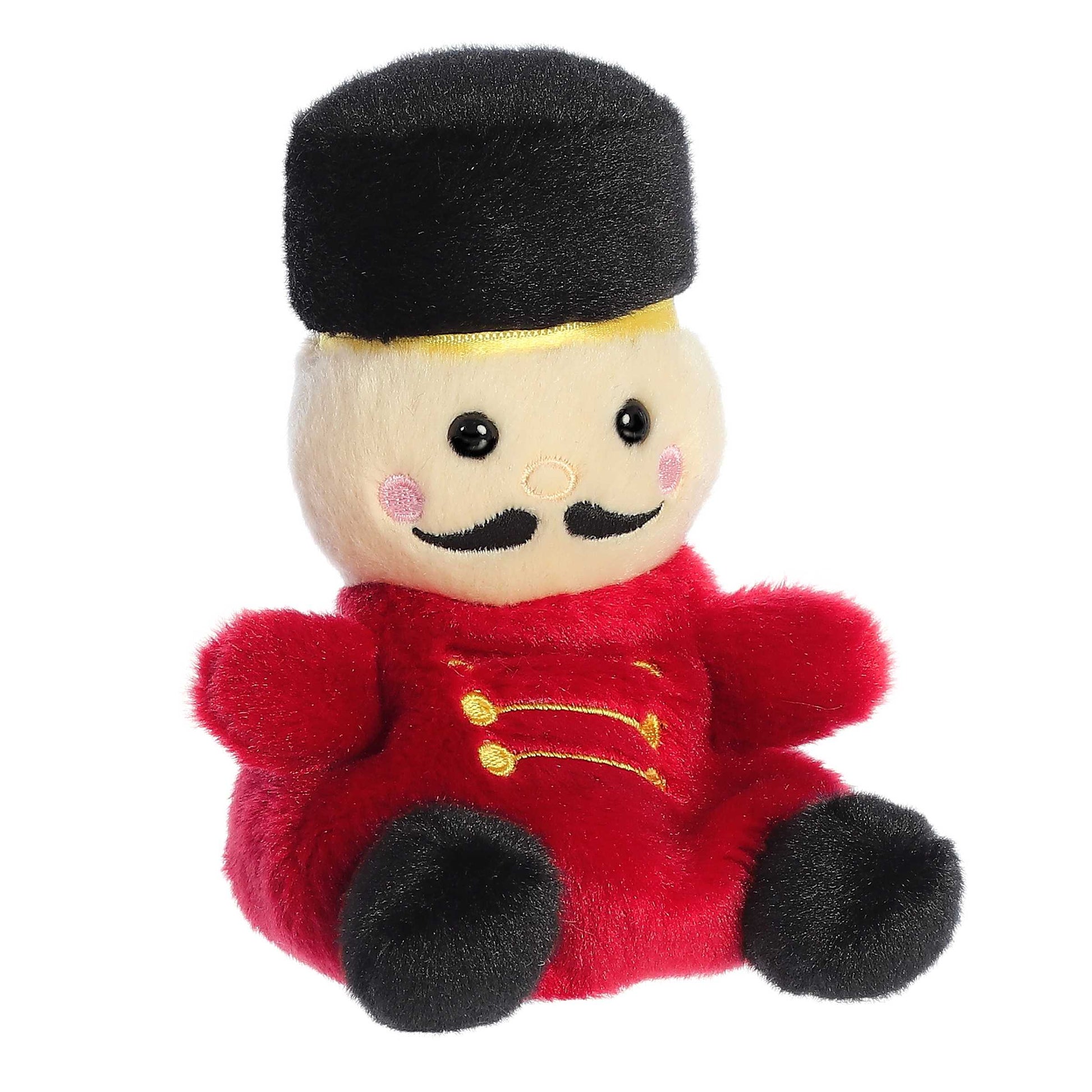 Palm Pals Marius Nutcracker plush featuring a red uniform with gold details, black boots, a black mustache, and a tall black fur hat.