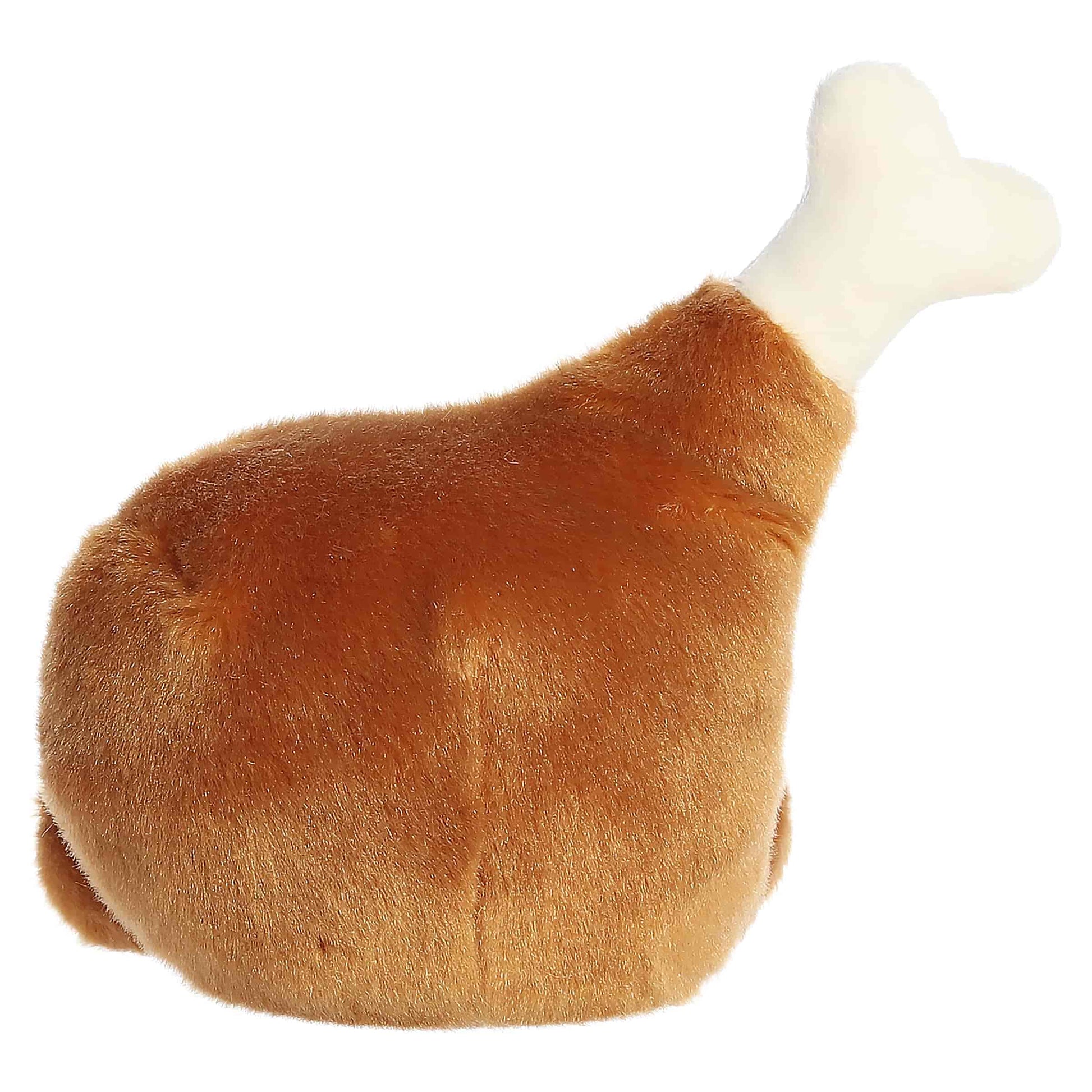 Palm Pals Mila Drumstick 6-inch golden-brown plush drumstick with a cream plush bone, embroidered smile, and rosy cheeks.
