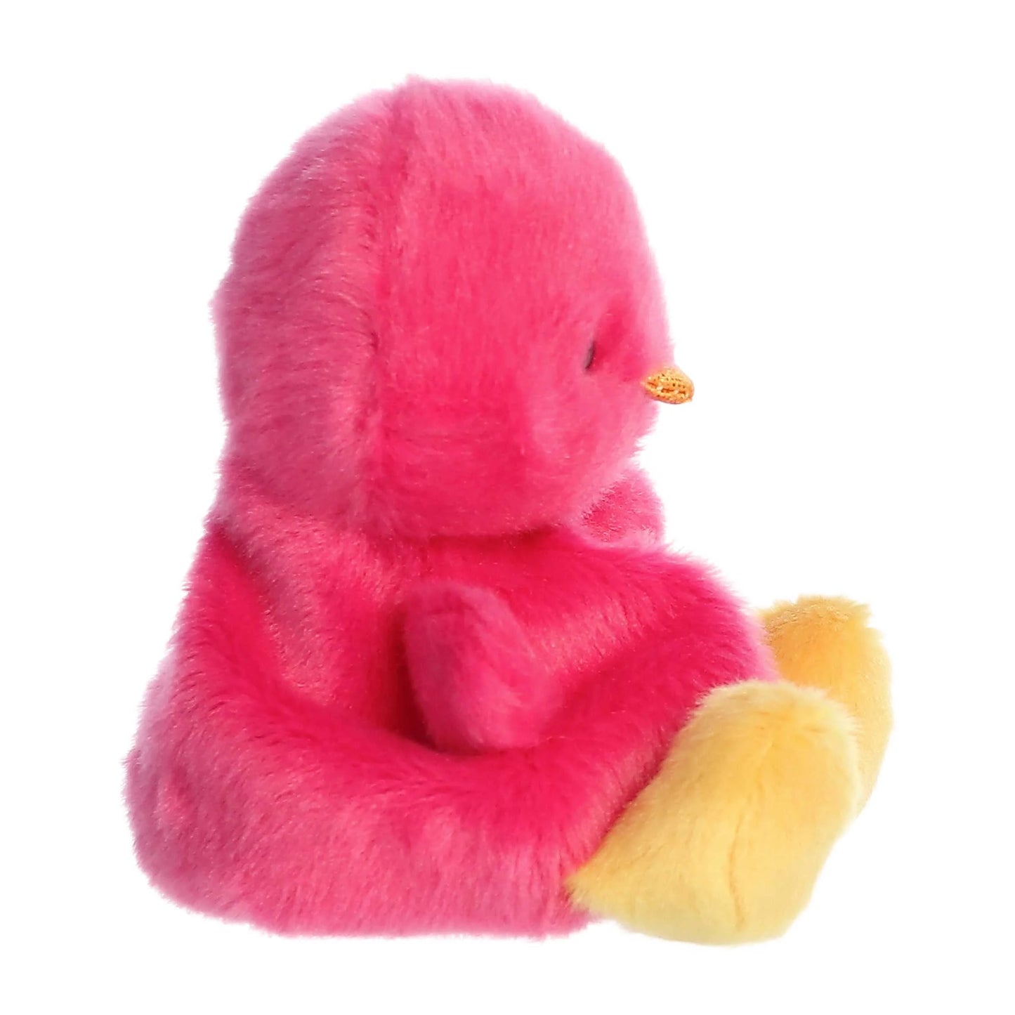 Pink plush duck with yellow feet on a white background