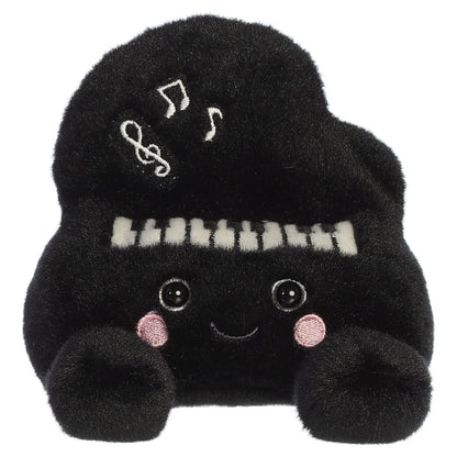Palm Pals Ragtime Piano plush toy in black with embroidered piano keys, white musical notes, a cute smiling face, and pink blush.