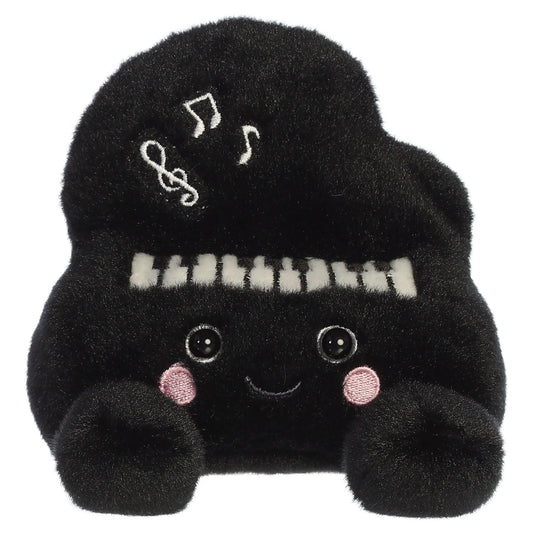 Palm Pals Ragtime Piano plush toy in black with embroidered piano keys, white musical notes, a cute smiling face, and pink blush.