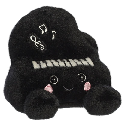 Palm Pals Ragtime Piano plush toy in black with embroidered piano keys, white musical notes, a cute smiling face, and pink blush.