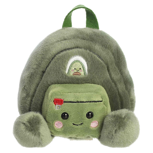 Palm Pals Rainier Backpack, a small green plush shaped like a backpack with a cute blushing face and an avocado patch.