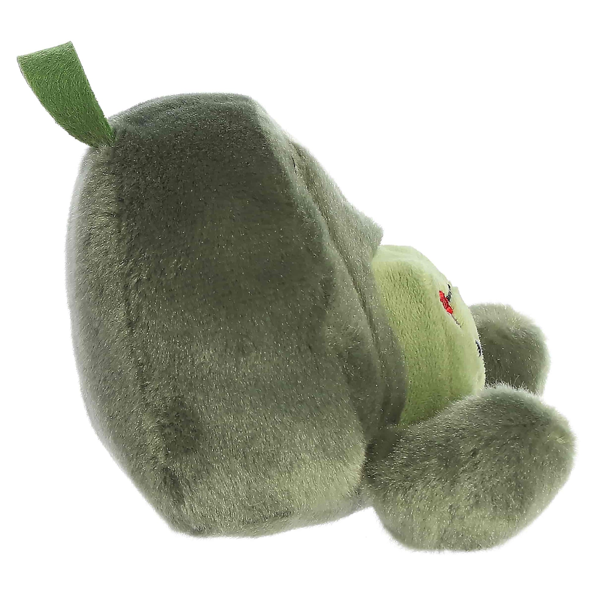 Palm Pals Rainier Backpack, a small green plush shaped like a backpack with a cute blushing face and an avocado patch.