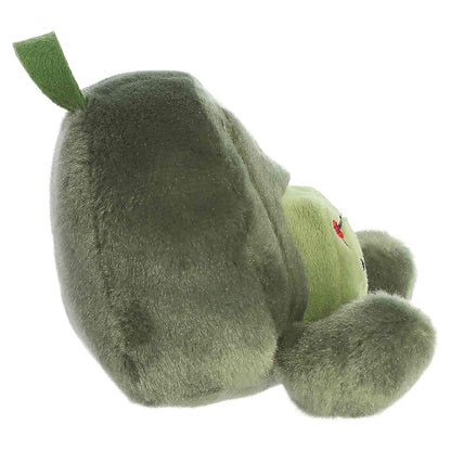 Palm Pals Rainier Backpack, a small green plush shaped like a backpack with a cute blushing face and an avocado patch.