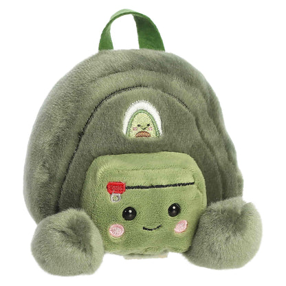 Palm Pals Rainier Backpack, a small green plush shaped like a backpack with a cute blushing face and an avocado patch.