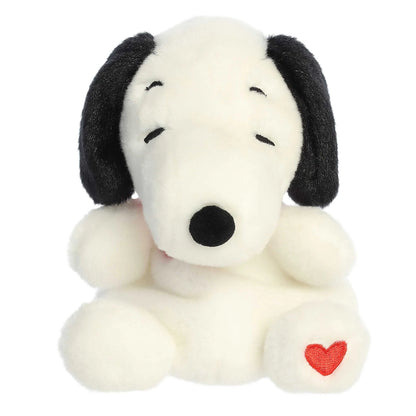 A product photo of the Palm Pals Snoopy Hearts plush, a white beagle stuffed animal with black ears, a red collar, and embroidered red hearts on its chest and foot.