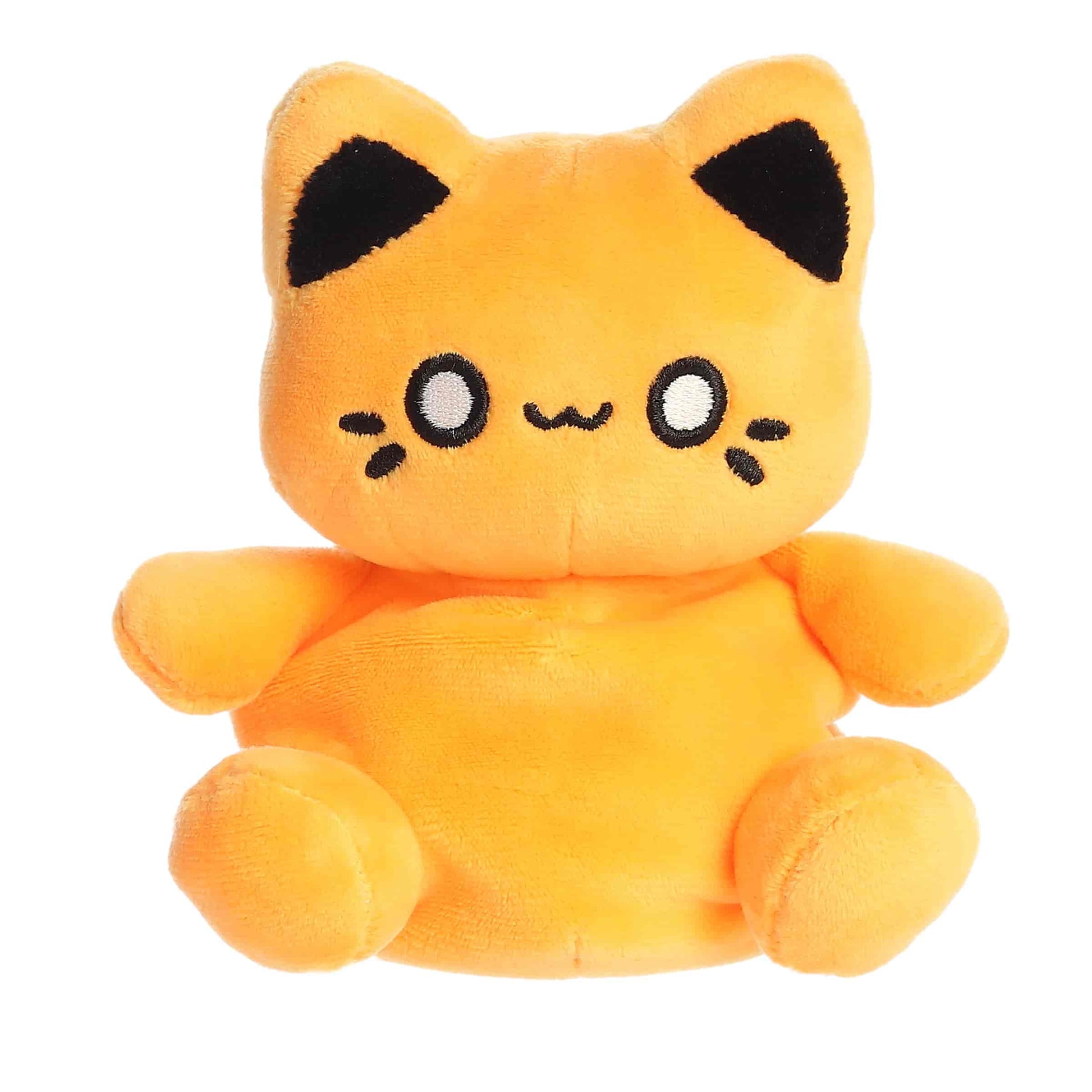 Palm Pals Tasty Peach Kinetic Orange Meowchi 5-inch plush soft toy, a bright orange cat with black ears and a happy embroidered face.