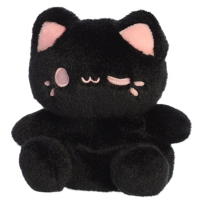 Palm Pals Tasty Peach Strawberry Black Out Meowchi plush toy with a soft black body, playful pink inner ears, and a winking embroidered smile