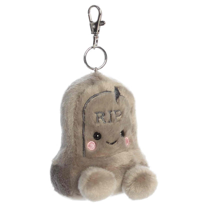 Palm Pals Thom Tombstone 3.5-inch plush clip-on featuring soft gray plush, embroidered RIP text, rosy cheeks, and a silver keychain clip.