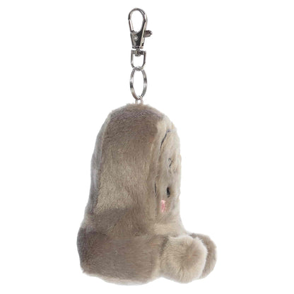 Palm Pals Thom Tombstone 3.5-inch plush clip-on featuring soft gray plush, embroidered RIP text, rosy cheeks, and a silver keychain clip.