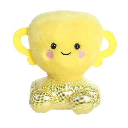 A product photo of the Palm Pals Winner Trophy 5-Inch Plush, a yellow stuffed trophy with a shiny metallic gold base and handles, sitting on a white background.