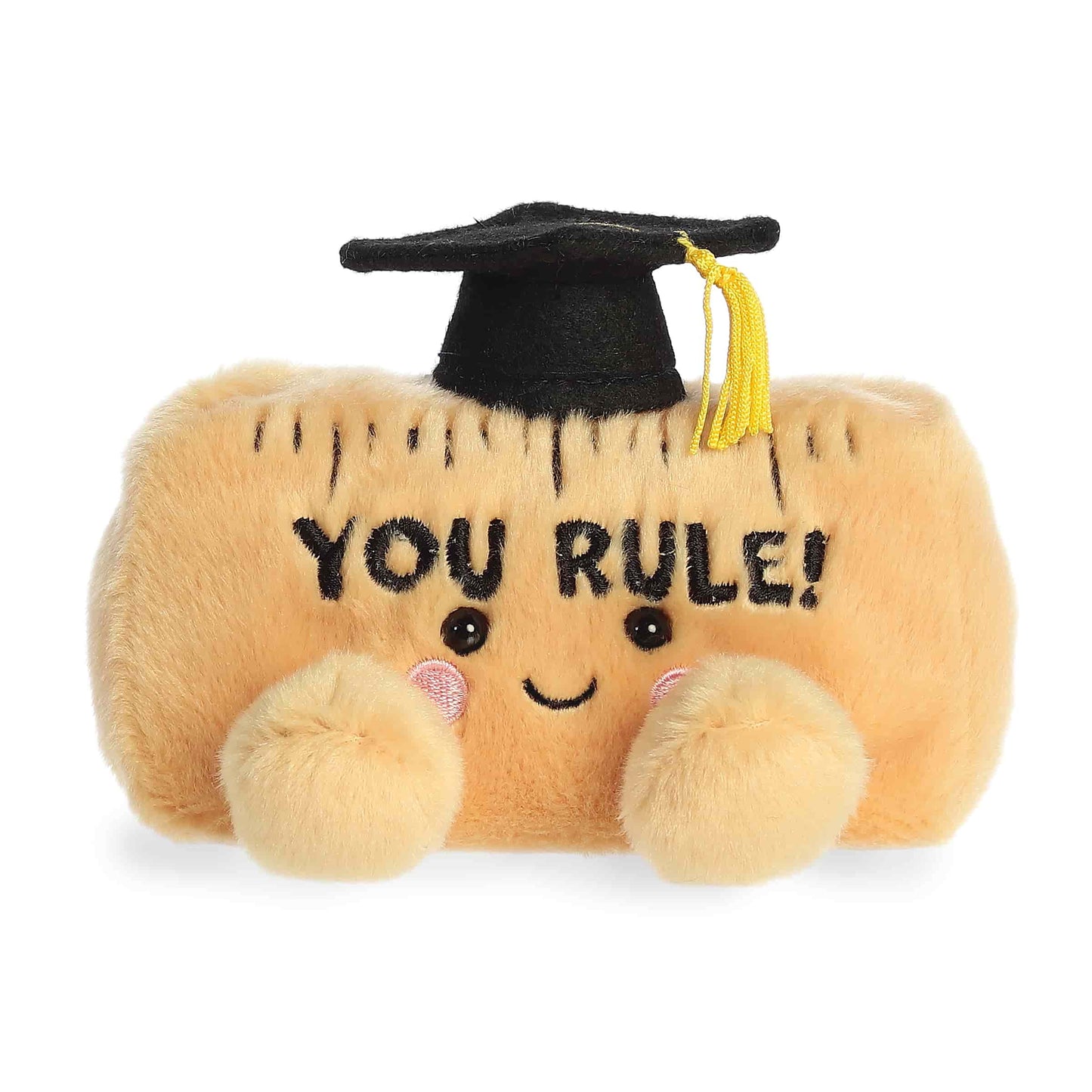 Product view of Palm Pals You Rule Ruler, a tan plush ruler wearing a black graduation cap with the text "YOU RULE!" embroidered on the front.