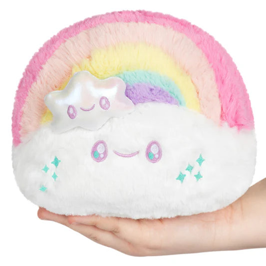 A small, 6-inch plush toy of a pastel rainbow (pink, yellow, blue, purple) sitting on a smiling white cloud. A small, shiny iridescent plush star with a face is attached to the front of the rainbow.