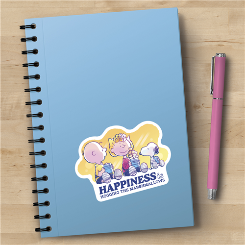 Notebook with cartoon design and pink pen on a wooden surface