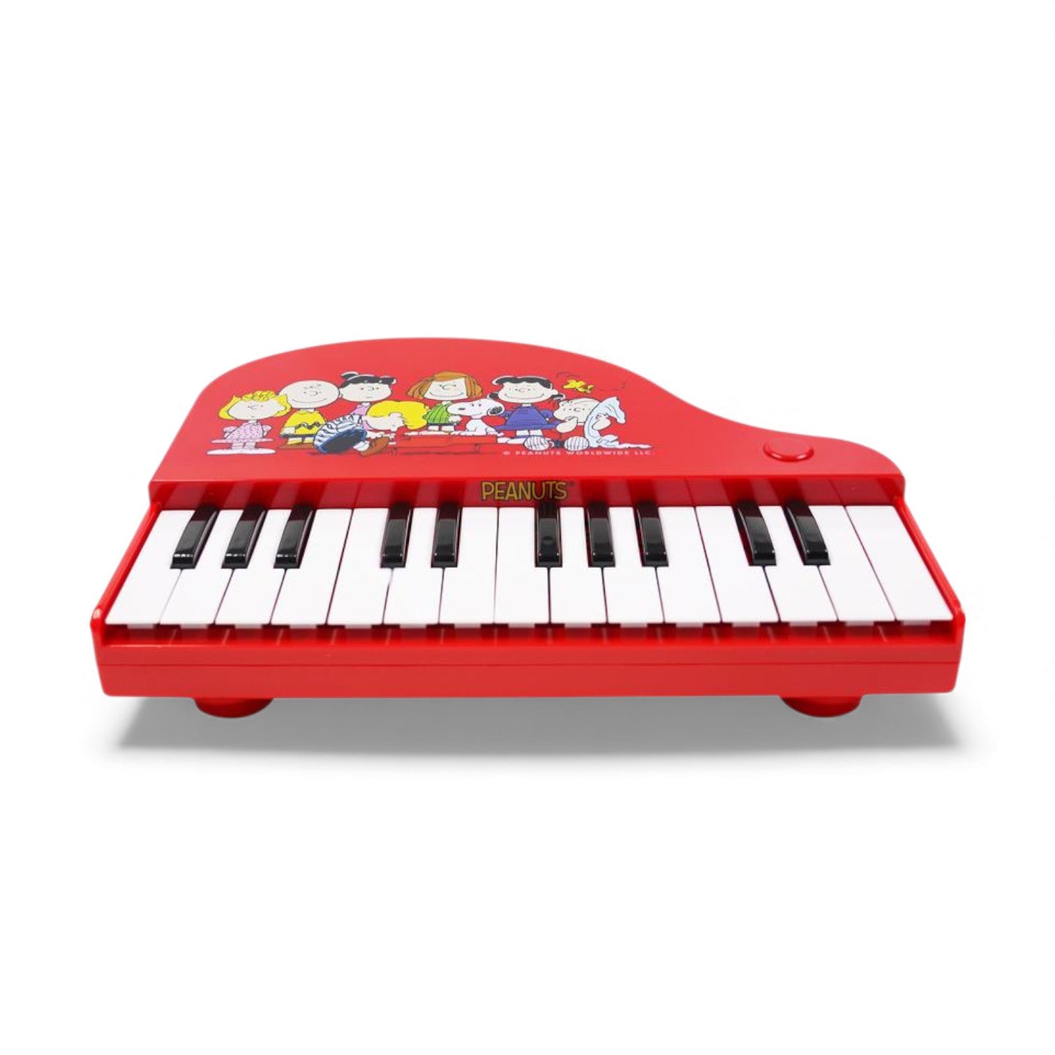 Product view of the Peanuts Schroeder's Piano, a red 25-note electronic keyboard featuring artwork of the Peanuts gang gathered around Schroeder.
