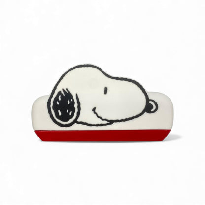 Product view of the Peanuts Snoopy Harmonica, a white and red musical instrument shaped like Snoopy's head.