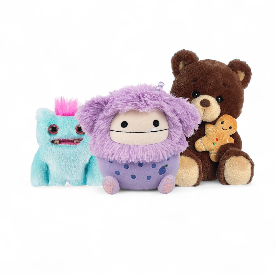 Three stuffed animals sitting with a white background.