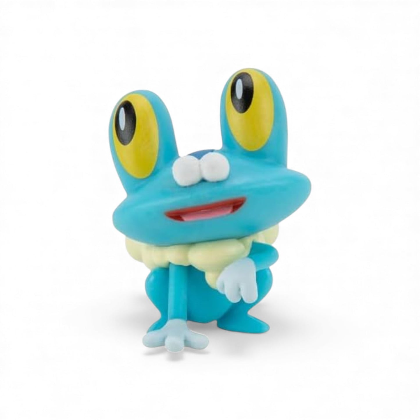 Toy frog figure with large eyes on a white background