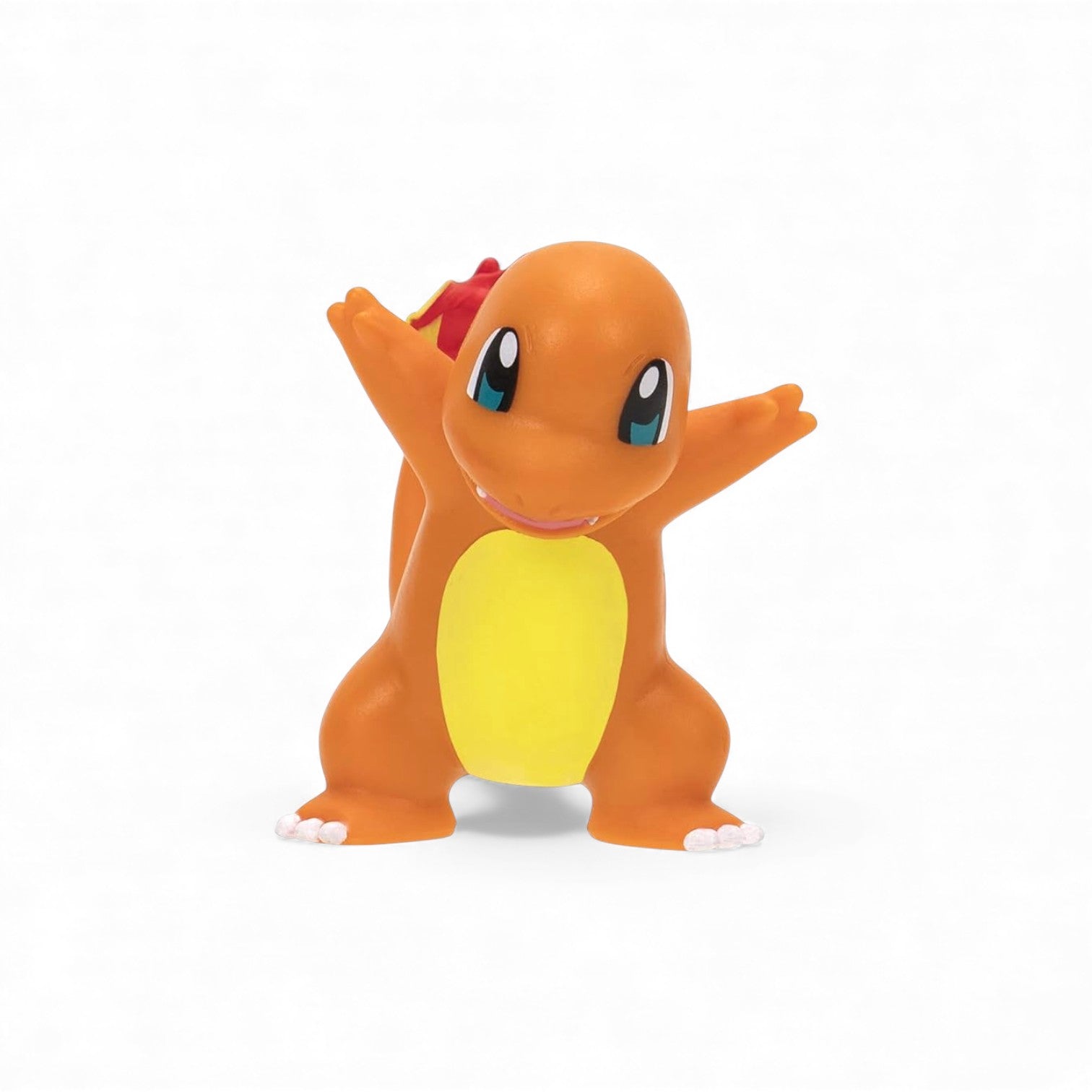 Toy figure of a dragon-like creature with orange body, yellow belly, and red crest on a white background