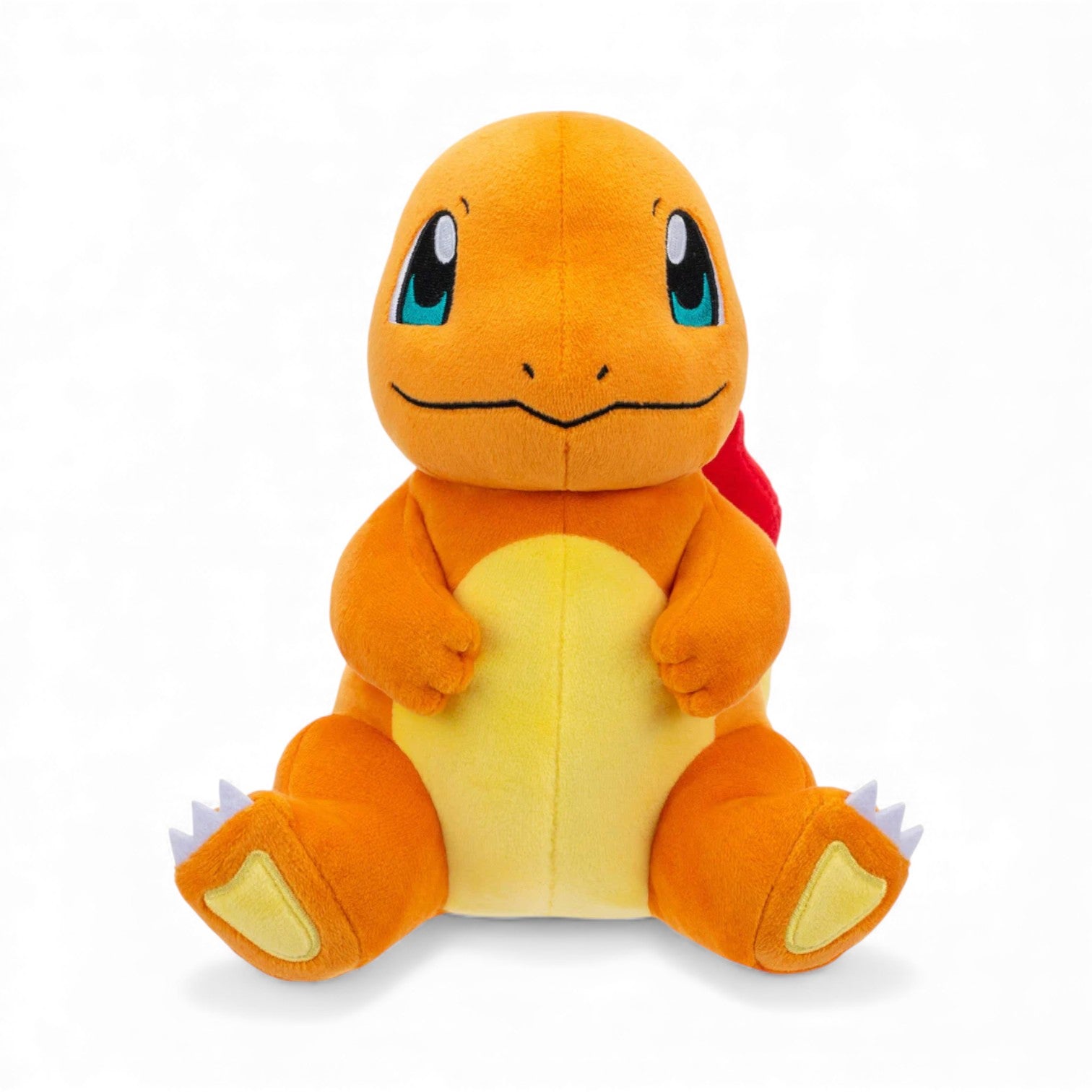 Front view of the Pokémon 8-Inch Charmander Plush, an orange Fire-type lizard with a cream belly and embroidered eyes, sitting in a happy pose.