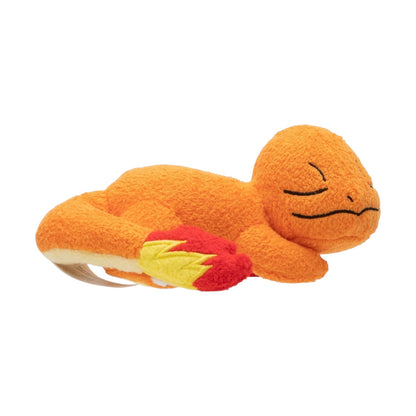 Side view of the Pokémon 5-Inch Sleeping Charmander Plush, lying on its stomach with closed eyes and a plush flame on its tail.