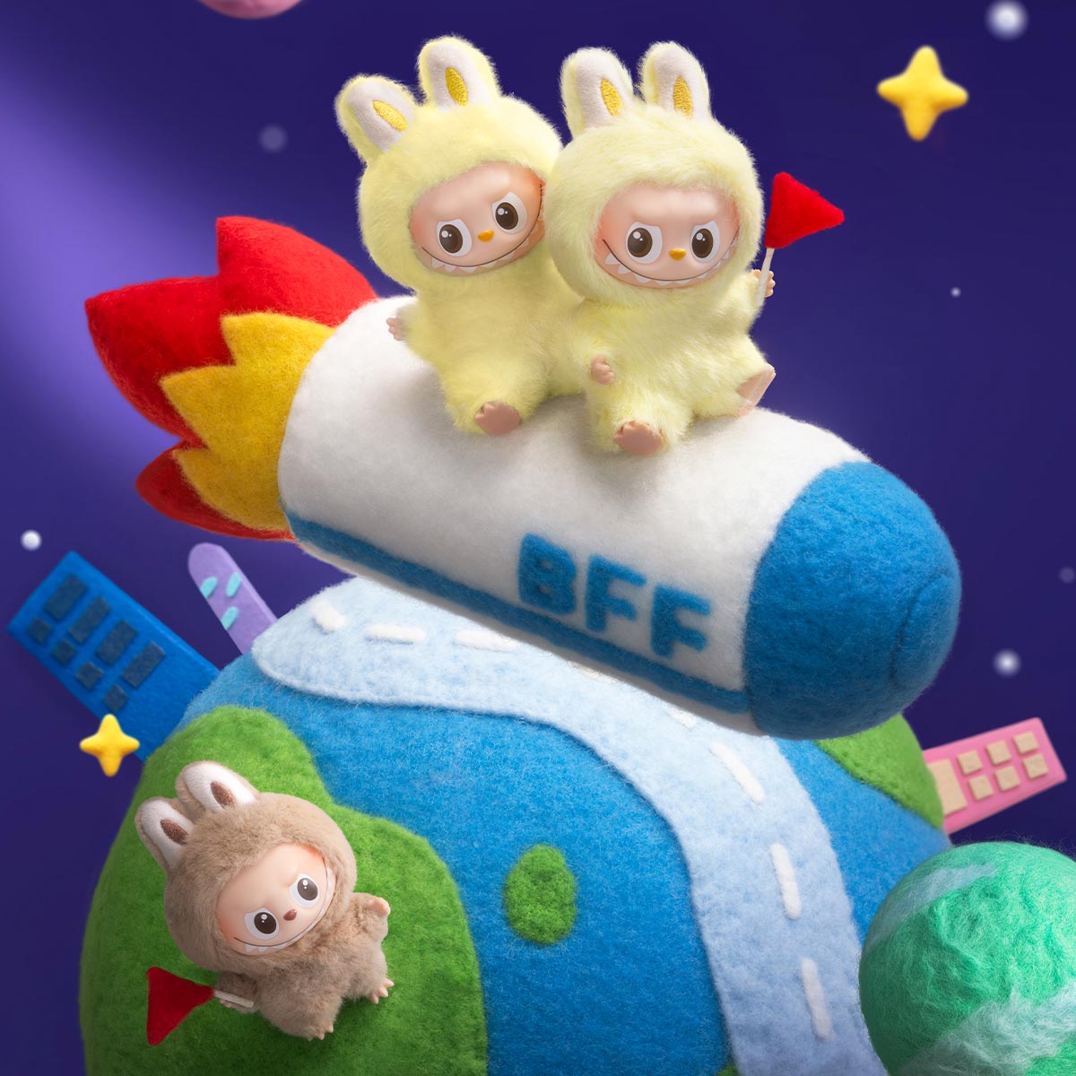 Toy rocket with two plush characters on top and a smaller character below, set against a colorful background.