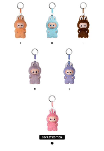 Set of colorful plush keychains on a white background