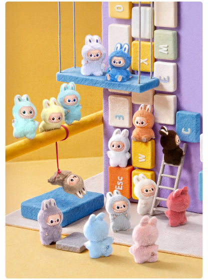 Colorful toy figures on a play structure with a yellow and purple background