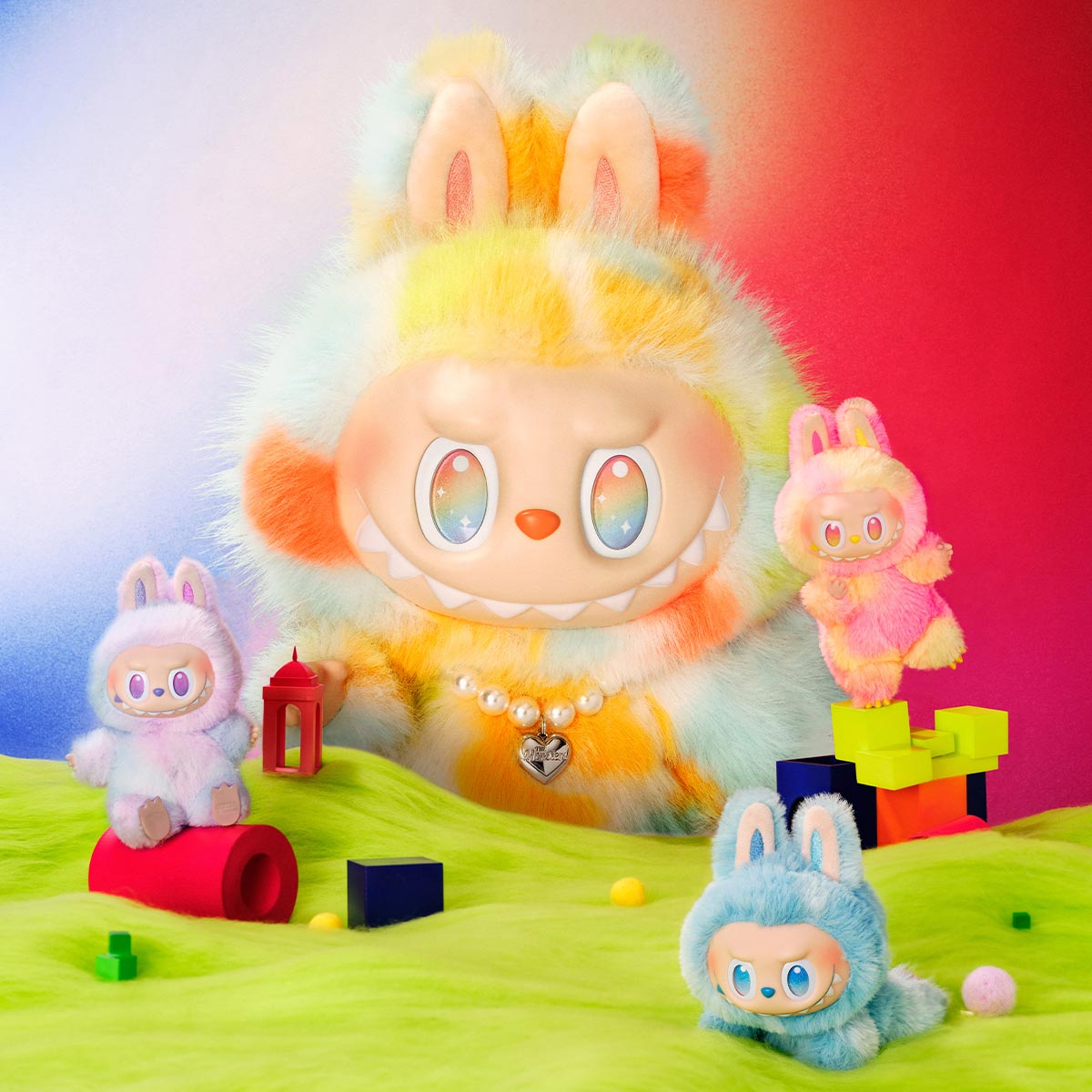 A product photo of the POP MART "Rock the Universe" Labubu, a large 14.57-inch vinyl plush doll with rainbow tie-dye fur and a pearl heart necklace with two other smaller Labubu plush. 
