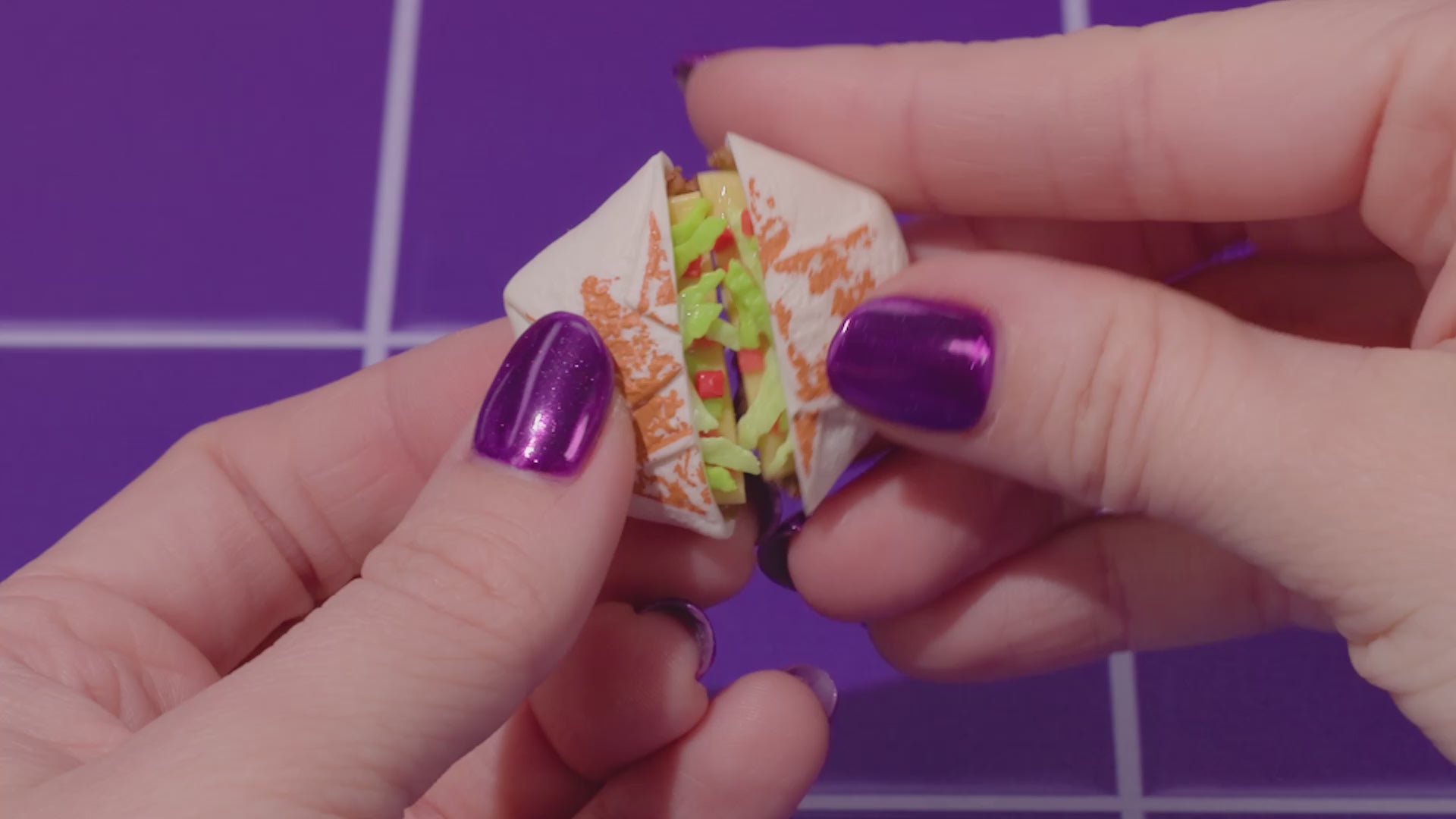 MGA's Miniverse Make It Mini Taco Bell surprise ball and various miniature food ingredients including a Crunchwrap Supreme and sour cream.